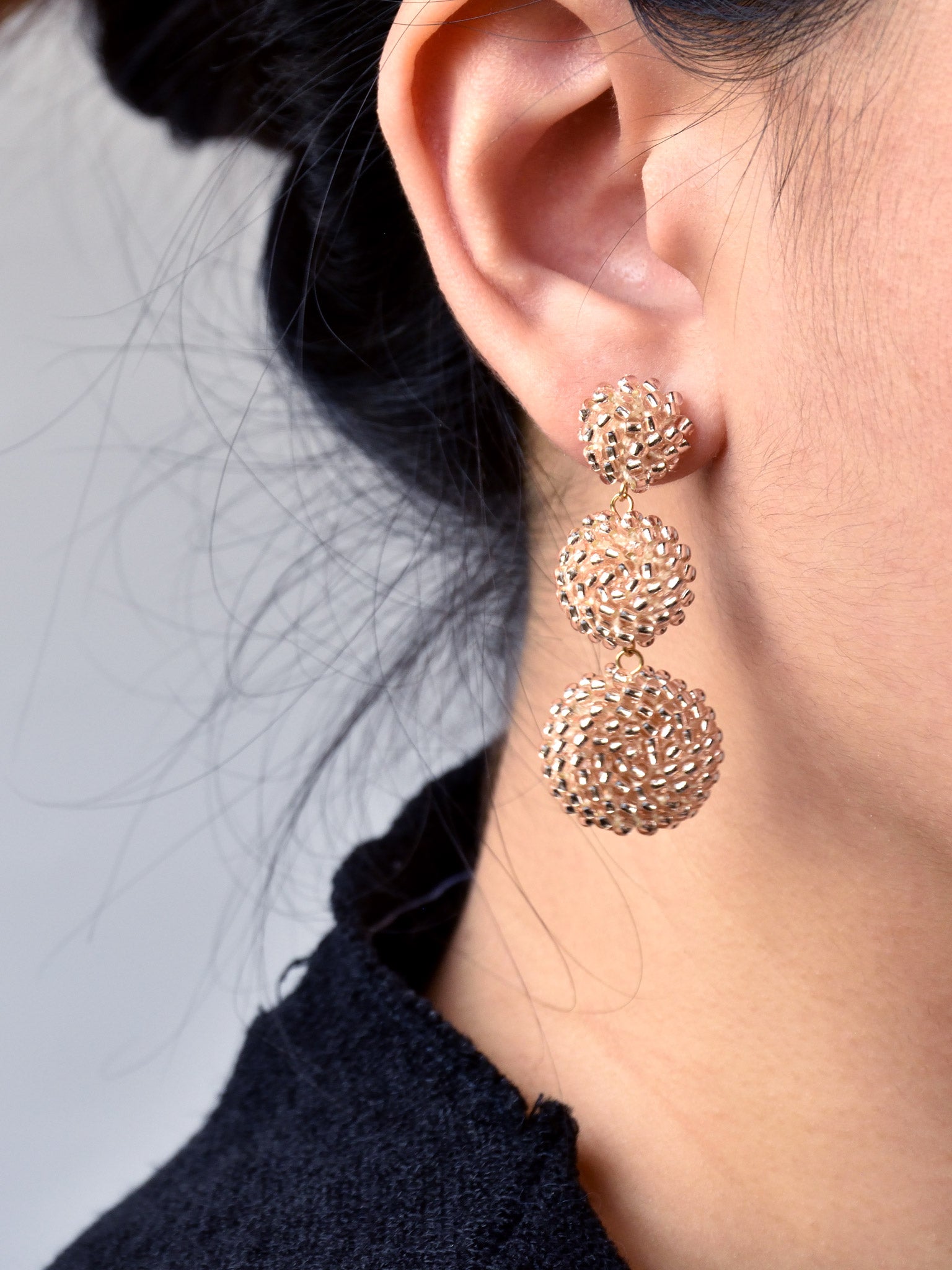 Juno Dangle Earrings in Champagne Pink Model 2